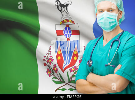 Surgeon with Canadian privinces flag on background - Yukon Stock Photo