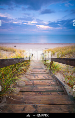 A staircase leading down grass covered dunes to a beach along the shore of Lake Huron. Pinery Provincial Park, Ontario, Canada. Stock Photo