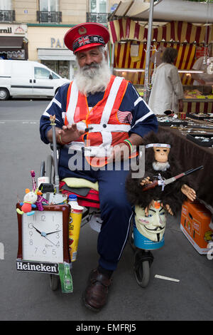 Portrait of a man with a physical disability sitting in a wheelchair asking for donations in Paris, France Stock Photo