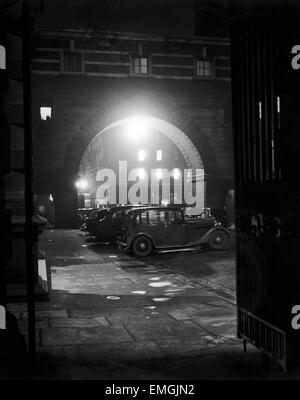 London by Night. View of motor cars parked outside Old Scotland Yard, headquarters of the Metroplotian Police Department in Whitehall, London, 1948. Stock Photo