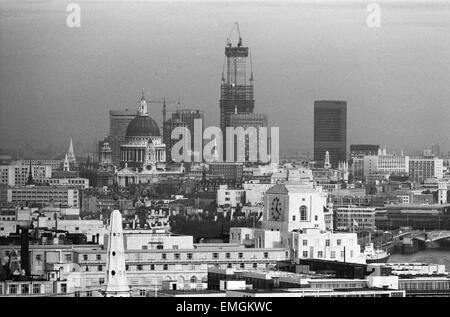 General view of the City of London during the construction of the National Westminster Bank at Bishopsgate, taken from New Zealand House in Haymarket. The building was later renamed Tower 42. Also in the picture is St Paul's Cathedral. 28th February 1977. Stock Photo