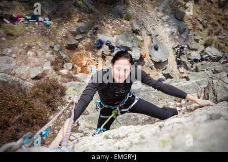 Young woman climbing wall, active woman concept picture. Stock Photo