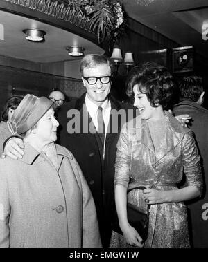 Michael Caine with his mother, Marie Micklewhite and leading lady Sue Lloyd at the Premiere of 'The Ipcress File' 19 March 1965 Stock Photo