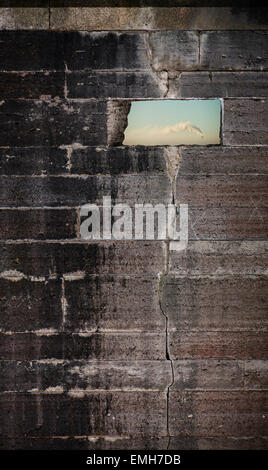 Opening in stone wall with sky and smoke from smokestack visible. Konceptual image of freedom and industry. Stock Photo