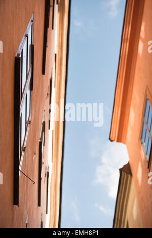 Low angle view of old buildings in Gamla Stan (Old Town) Stockholm, Sweden. The houses are close to each other with a narrow alley between. Stock Photo