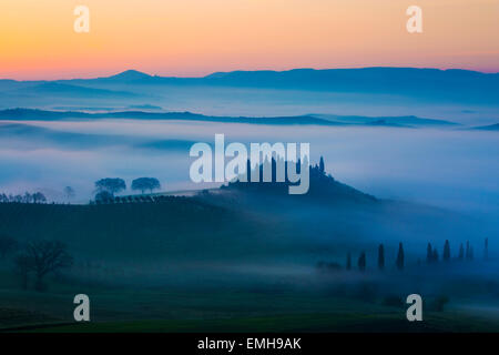 Podere Belvedere and the Tuscan countryside at dawn, San Quirico d'Orcia, Tuscany, Italy Stock Photo