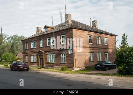 Two cars are parked in front of the old traditional wooden house in Kallaste, eastern Estonia. Stock Photo