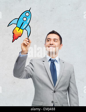 happy businessman in suit writing something Stock Photo