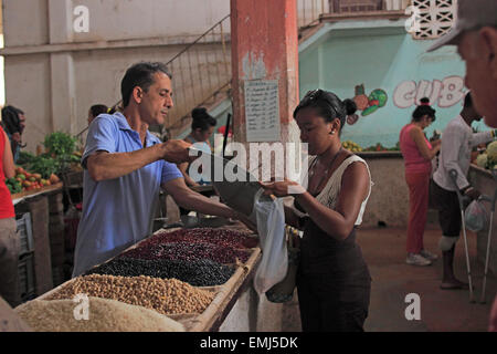 Cuban woman buying beans in market showing products available for sale Cienfuegos Cuba Stock Photo