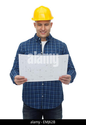 smiling male builder in helmet with blueprint Stock Photo