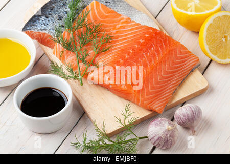 Salmon, spices and condiments on wooden table Stock Photo