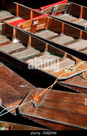 A close up of punts moored up on the river Cherwell at Magdalen bridge in the city of Oxford, England