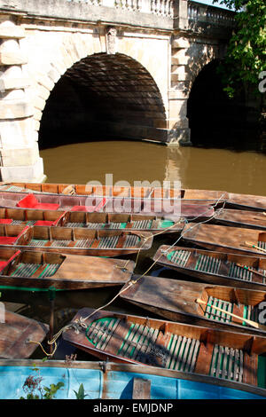 Punts moored up on the river Cherwell at Magdalen bridge in the city of Oxford, England