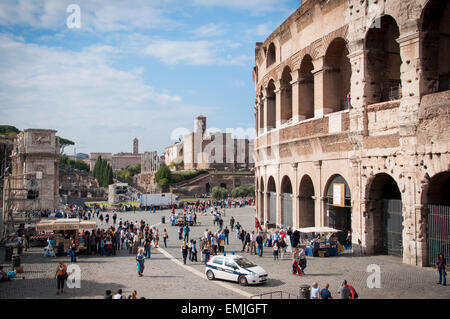 Cityscape of tourists in front of the Colosseum, Arch of Constantine and the Roman Forum in the background, Rome, Italy Stock Photo