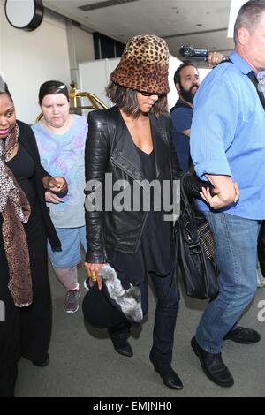 A camera shy Halle Berry conceals her face with a leopard print hat as she arrives at Los Angeles International Airport (LAX)  Featuring: Halle Berry Where: Los Angeles, California, United States When: 17 Oct 2014 Stock Photo