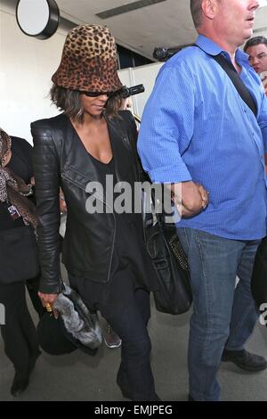 A camera shy Halle Berry conceals her face with a leopard print hat as she arrives at Los Angeles International Airport (LAX)  Featuring: Halle Berry Where: Los Angeles, California, United States When: 17 Oct 2014 Stock Photo