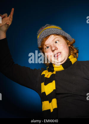 Expressive teenage boy dressed in colorful hat close-up studio portrait, isolated Stock Photo