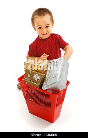 Little boy throwing nice presents in garbage bin. Concept of kids overwhelmed with unusable gadgets Stock Photo