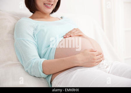The pregnant woman lying in bed Stock Photo
