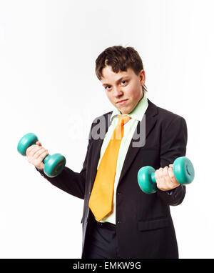Teenage boy dressed in office suit doing sport exercises with dumbbells Stock Photo