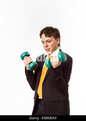 Teenage boy dressed in office suit doing sport exercises with dumbbells Stock Photo