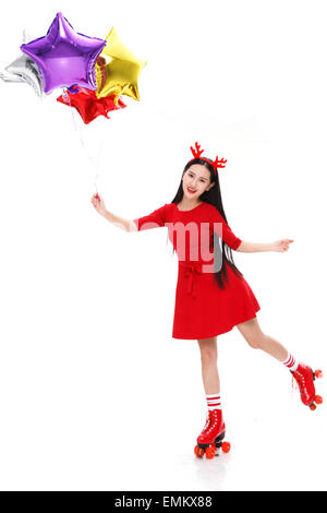 A young woman with a balloon in the roller skating Stock Photo