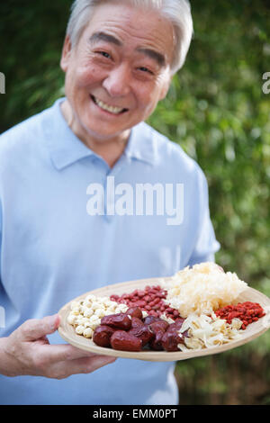 An old man with a dried fruit Stock Photo