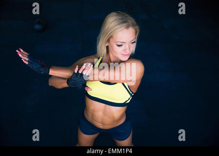 Young beautiful sporty woman stretching hands Stock Photo