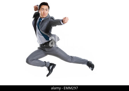 A young business man practicing kung fu Stock Photo