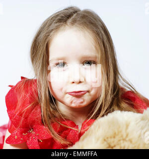 Cute little girl dressed like princess with her teddy-bear toy friend Stock Photo