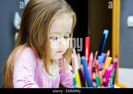 Cute little girl studing to speaking and writing letters at home lesson with her mother Stock Photo