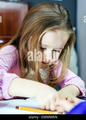 Cute little girl studing to speaking and writing letters at home lesson with her mother Stock Photo