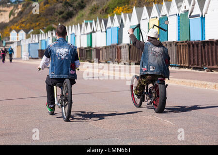 Bournemouth, Dorset, UK. 22nd April, 2015. Cycling along the promenade past beach huts at Alum Chine on a sunny day in April. Credit:  Carolyn Jenkins/Alamy Live News Stock Photo