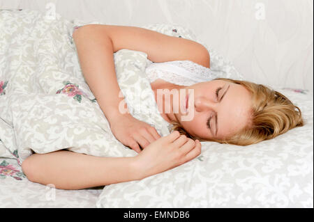 Beautiful young woman sleeping in bed Stock Photo