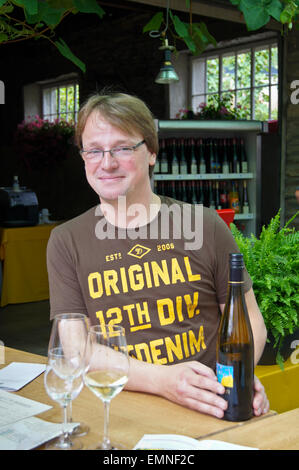 Markus Berres, winemaker, C.H. Berres, with a bottle of his Impulse Riesling wine Ürzig, Mosel valley, Rheinland-Pfalz, Germany Stock Photo