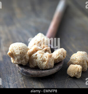 Raw Soya Chunks (Soy Meat) on wooden table, close up Stock Photo