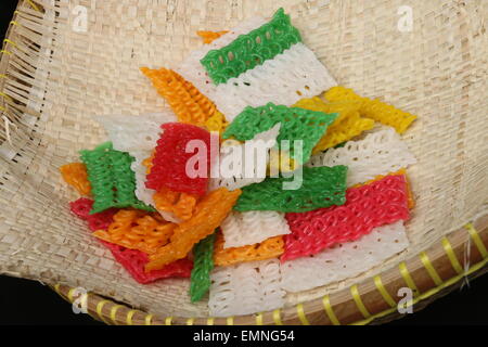 A handful of colorful curly crackers (Kasandra cracker) made from tapioca flour from West Java province of Indonesia Stock Photo
