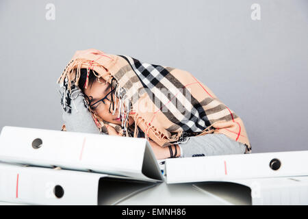 Young asian man sleeping with blanket on the table in office Stock Photo