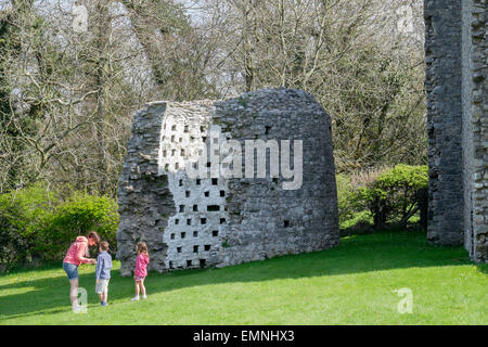 Woman with two children visiting the Dovecote in grounds of Oxwich castle on Gower Peninsula, Oxwich, Swansea, South Wales, UK Stock Photo