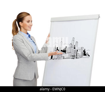 smiling businesswoman standing next to flipboard Stock Photo