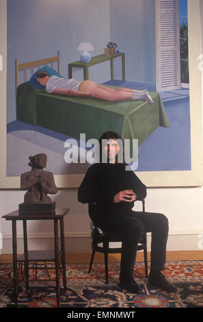 Ivor Braka  art dealer at home, with David Hockney on wall 'The Room, Tarzana, 1967'  1990s UK HOMER SYKES Stock Photo