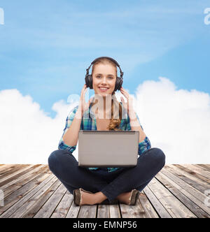 young woman in casual clothes sitting on floor Stock Photo