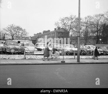 A woman and a pram pass a deserted second hand car lot in the Kings Road Chelsea. 23rd February 1960 Stock Photo