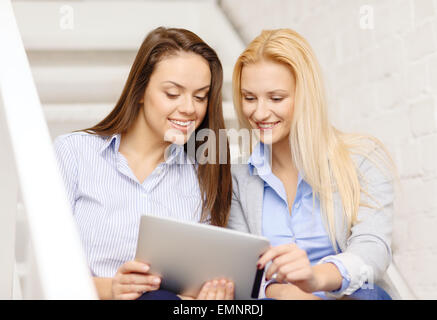 team with tablet pc computer sitting on staircase Stock Photo