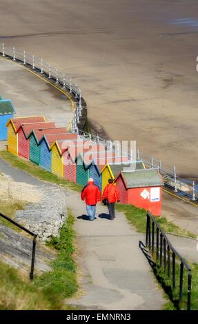 Brightly coloured beach huts on the sea front in Whitby ,North Yorkshire, England,uk Stock Photo