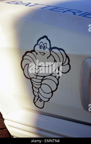 A Michelin Man decal on the side of a car at a car show. Stock Photo