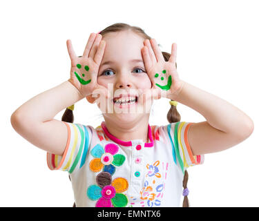 Happy kid girl showing painted hands with funny face Stock Photo