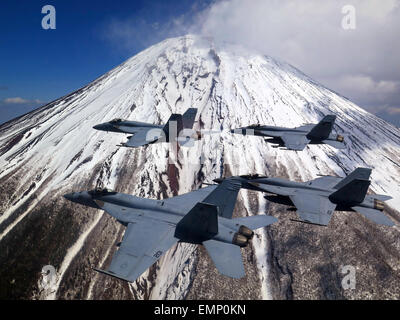 A US Navy F/A-18E Super Hornets fighter aircraft conduct a flyby in formation of Mount Fuji March 25, 2015 in Japan. Stock Photo
