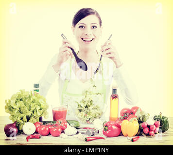 Retro filtered photo of a happy housewife preparing salad, healthy food or diet concept. Stock Photo