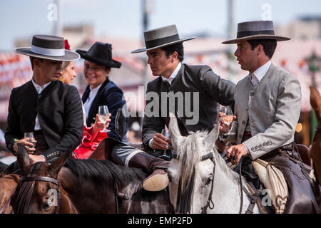 Seville, Andalucia, Spain. 22nd Apr, 2015. A group of horsemen drink at the 'Feria de Abril' (April's Fair), Seville, Spain, 22 april, 2015. Credit:  Daniel González Acuña/Alamy Live News Stock Photo